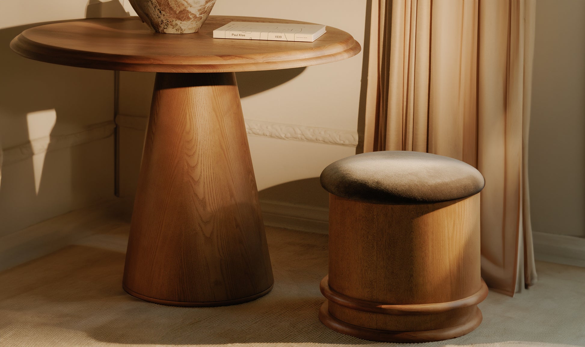 Wooden table and stool in a room with curtains