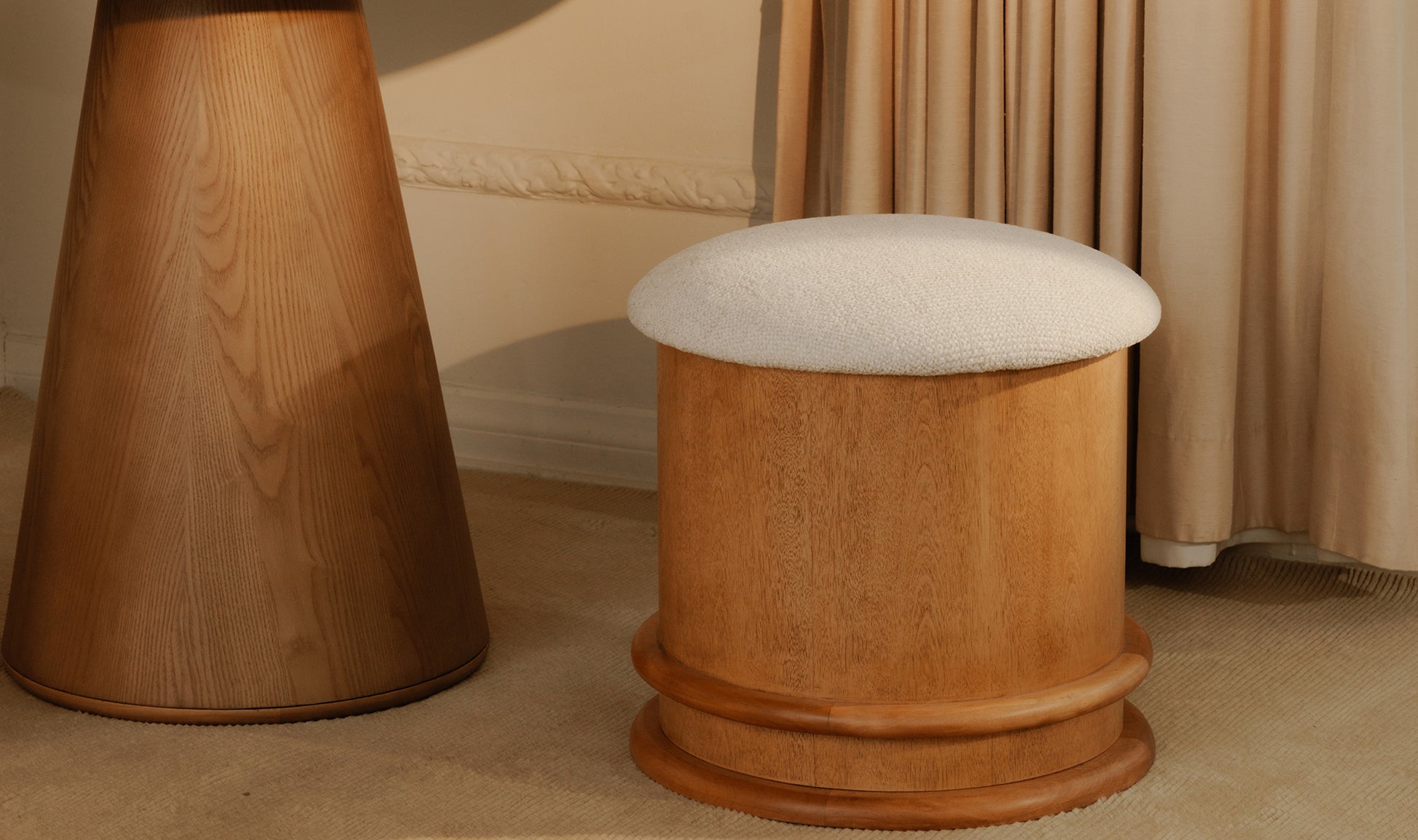 Wooden stool with a cushioned seat in a room setting