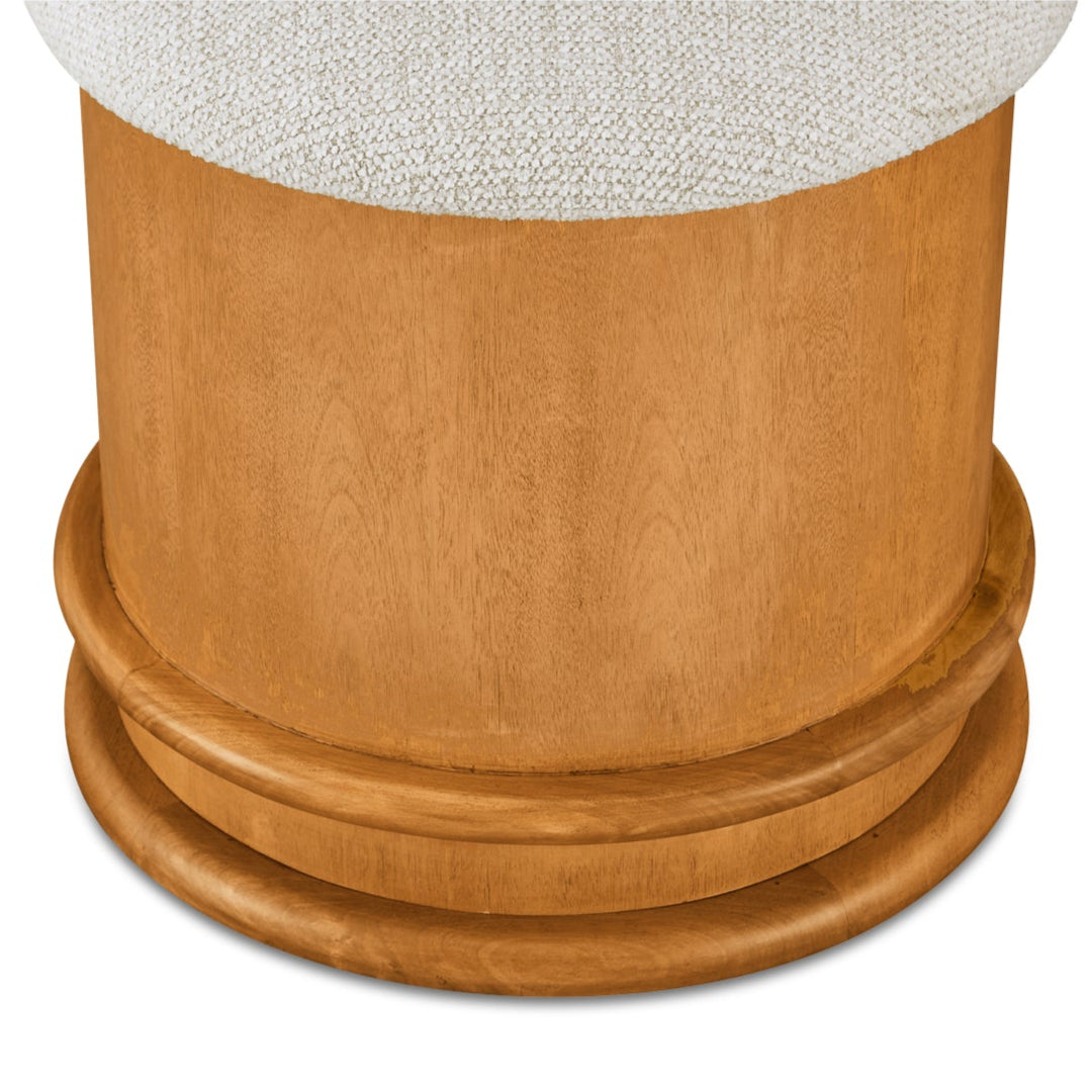 Wooden pedestal with textured white top on a white background